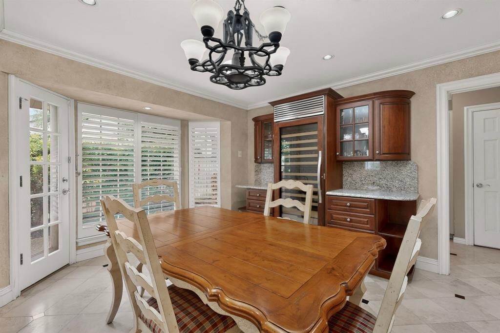 2405 Wing Point Lane Plano, TX 75093 - Photo 19 of 39 a dining room with furniture a chandelier and window