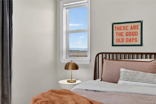 a bedroom with a bed and window
