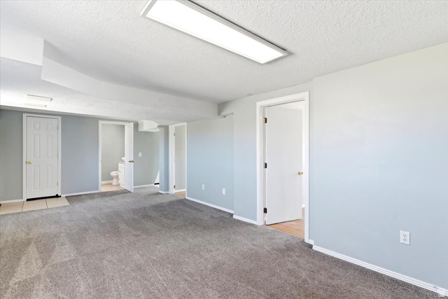 1613 Sunset Road Lake Point, UT 84074 - Photo 19 of 33 Spacious room featuring light blue walls and neutral gray carpeting
