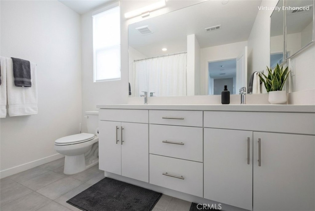 9412 Shade Place Rancho Cucamonga, CA 91730 - Photo 14 of 31 a bathroom with a toilet sink and mirror