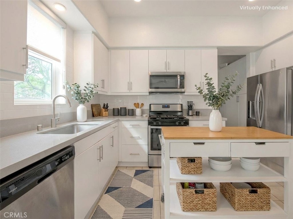 9412 Shade Place Rancho Cucamonga, CA 91730 - Photo 5 of 31 a kitchen with stainless steel appliances a stove refrigerator sink and white cabinets