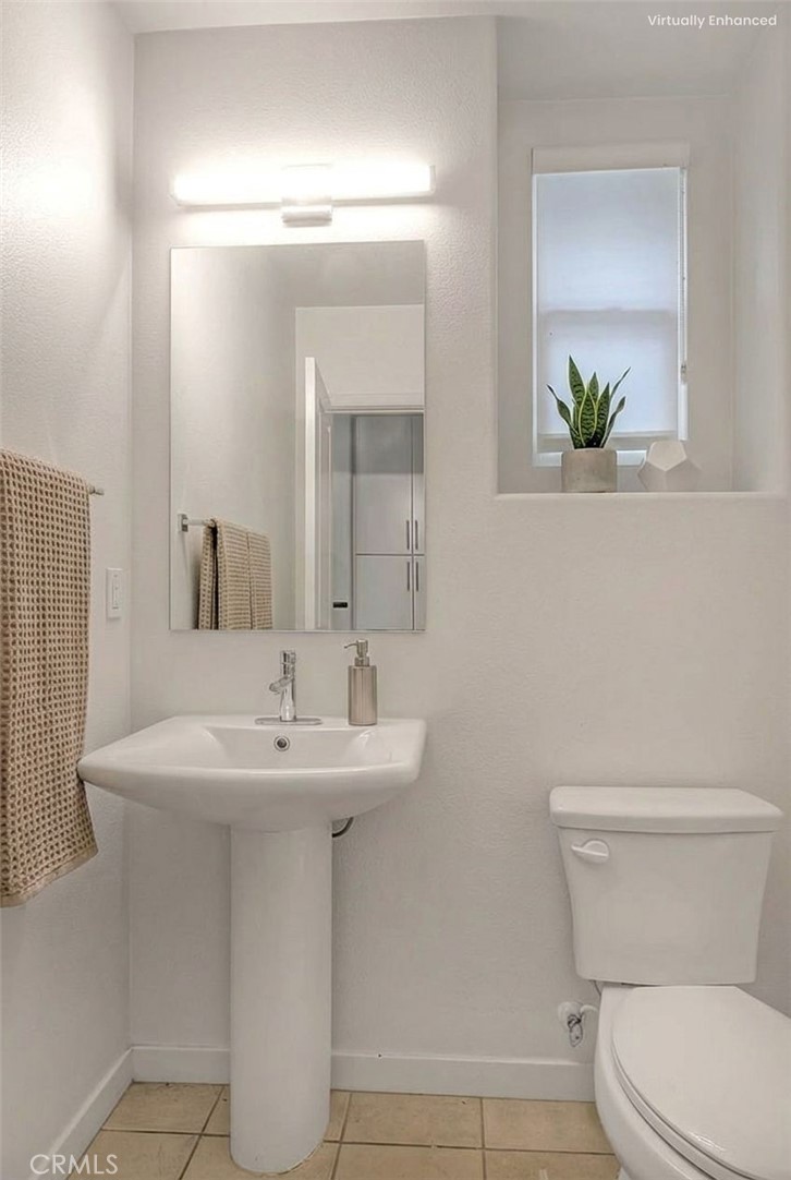 9412 Shade Place Rancho Cucamonga, CA 91730 - Photo 6 of 31 a bathroom with a toilet sink and mirror