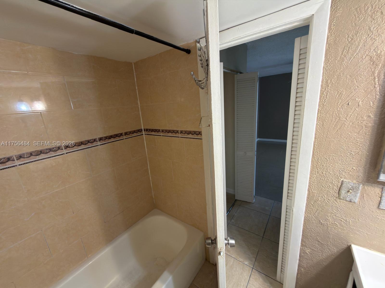 3400 Foxcroft Road, Unit 212 Miramar, FL 33025 - Photo 13 of 22 a bathroom with a shower and a tub