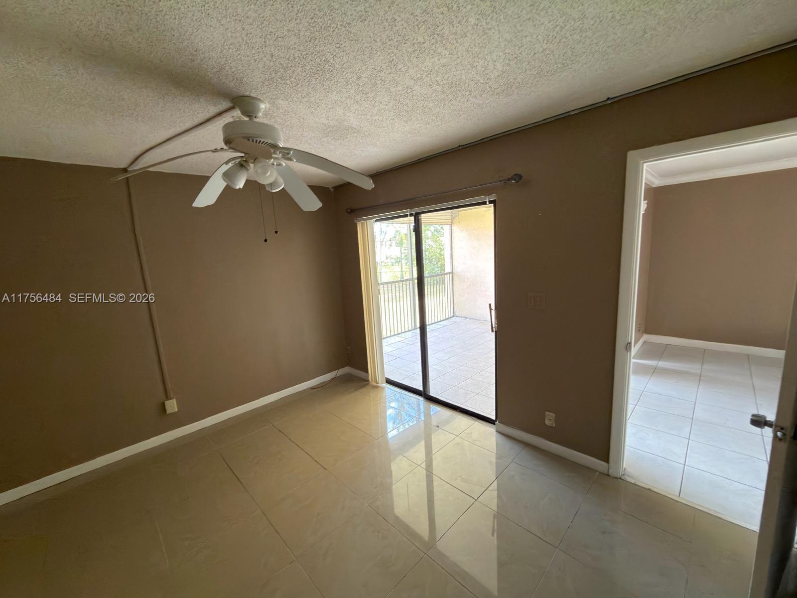 3400 Foxcroft Road, Unit 212 Miramar, FL 33025 - Photo 15 of 22 an empty room with windows and fan