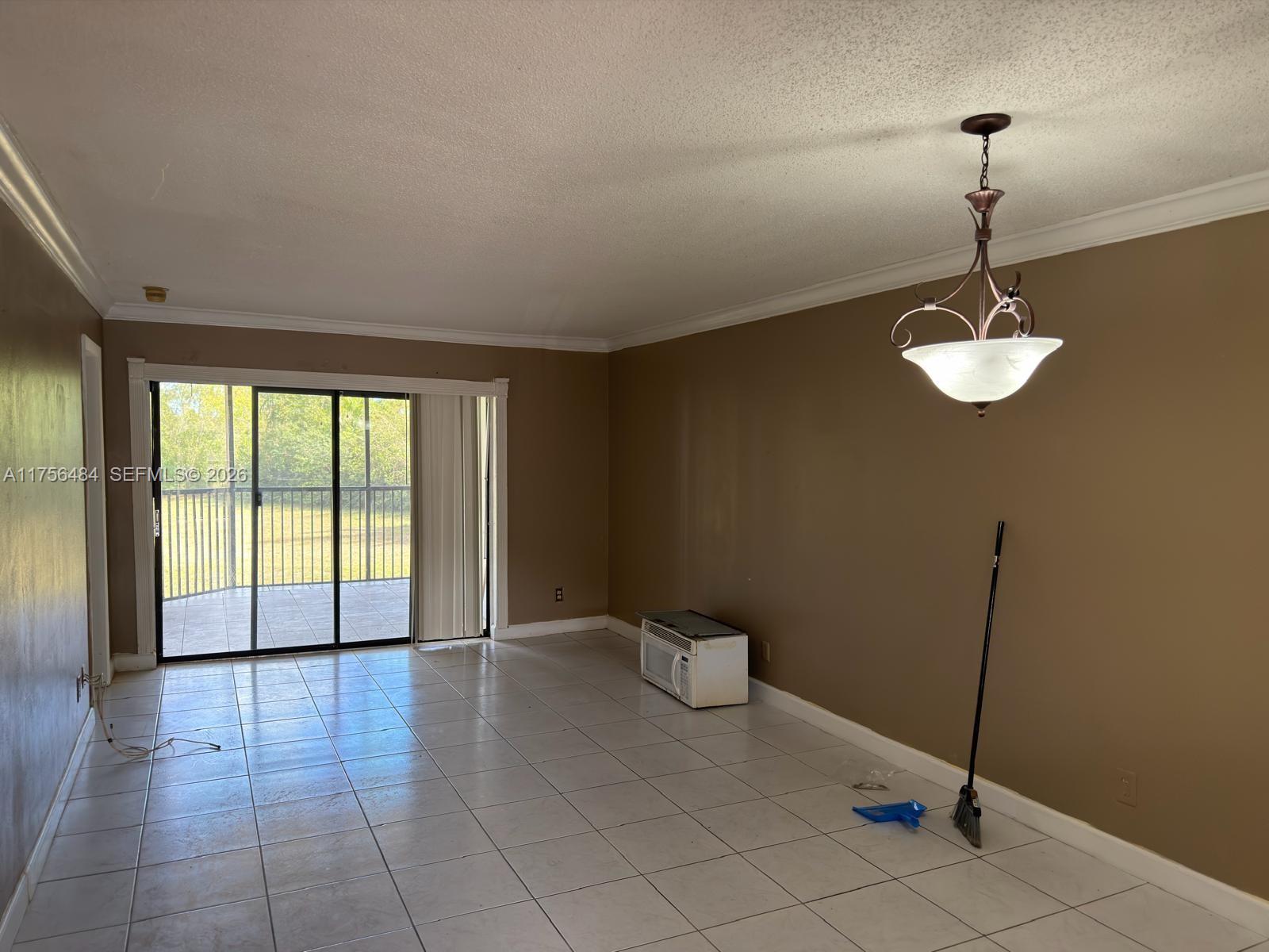 3400 Foxcroft Road, Unit 212 Miramar, FL 33025 - Photo 3 of 22 a view of a room with a chandelier