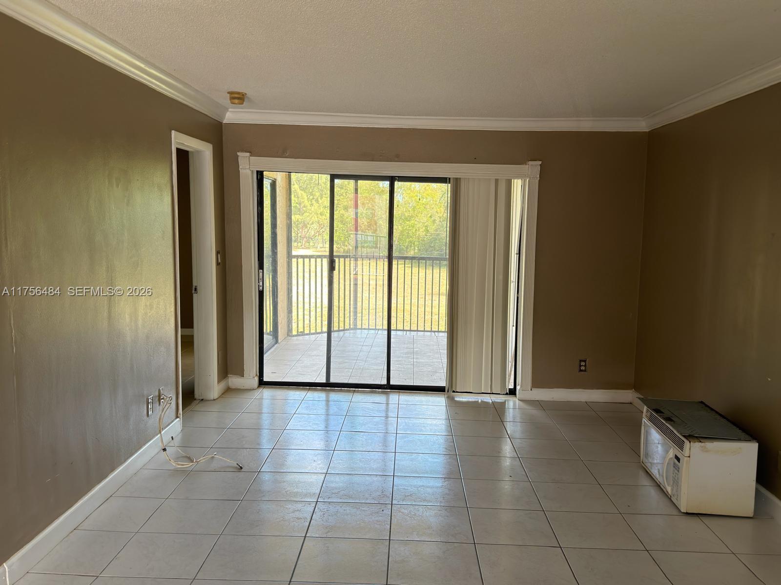 3400 Foxcroft Road, Unit 212 Miramar, FL 33025 - Photo 4 of 22 a view of an empty room with a window