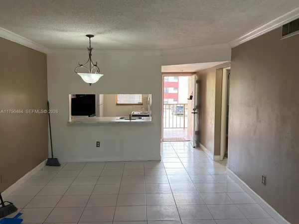 a view of a kitchen with an empty space and a window