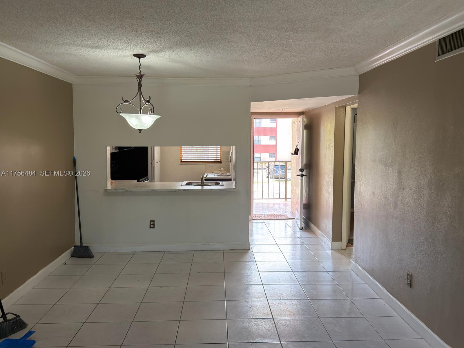 3400 Foxcroft Road, Unit 212 Miramar, FL 33025 - Photo 5 of 22 a view of a kitchen with an empty space and a window