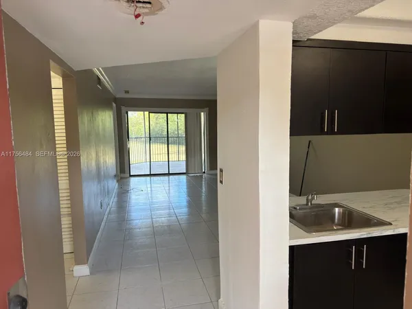 a view of a kitchen with a sink and a window