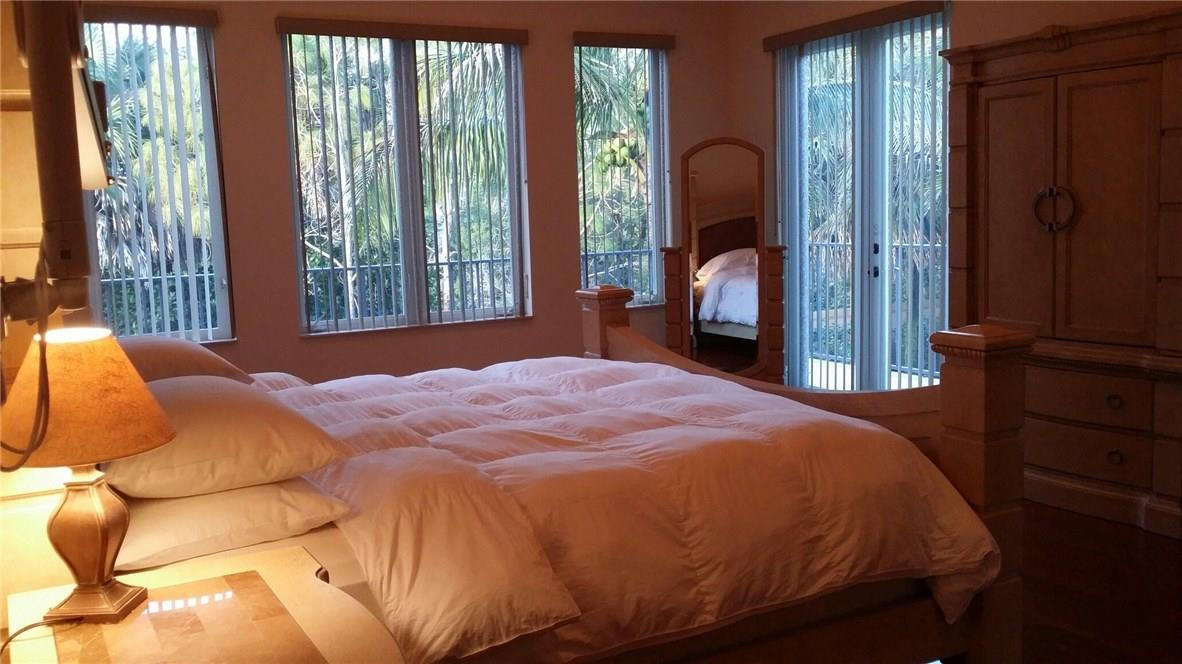 17665 Middlebrook Way Boca Raton, FL 33496 - Photo 11 of 17 a bedroom with a bed and a large mirror next to a window