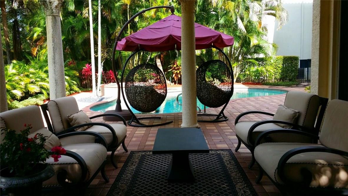 17665 Middlebrook Way Boca Raton, FL 33496 - Photo 14 of 17 a backyard of a house with barbeque oven table and chairs