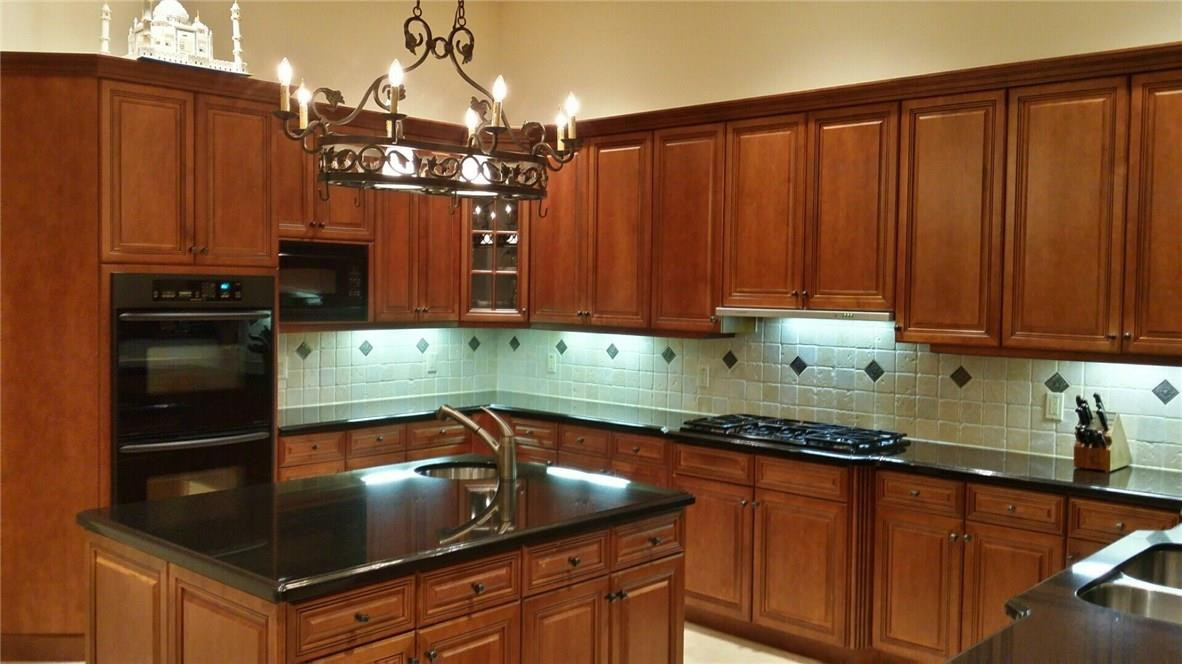 17665 Middlebrook Way Boca Raton, FL 33496 - Photo 3 of 17 a kitchen with stainless steel appliances granite countertop a sink a stove and a cabinets