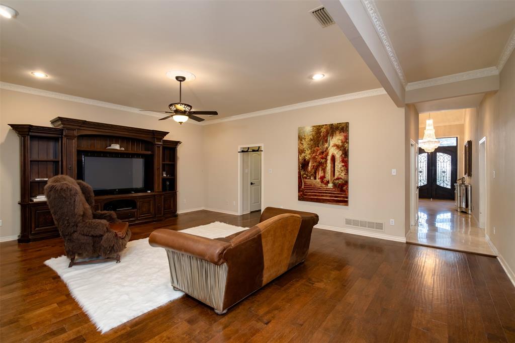 5920 Encore Drive Dallas, TX 75240 - Photo 11 of 34 Spacious interior featuring wood-finish flooring, a built-in media center with shelving, recessed lighting, and a ceiling fan