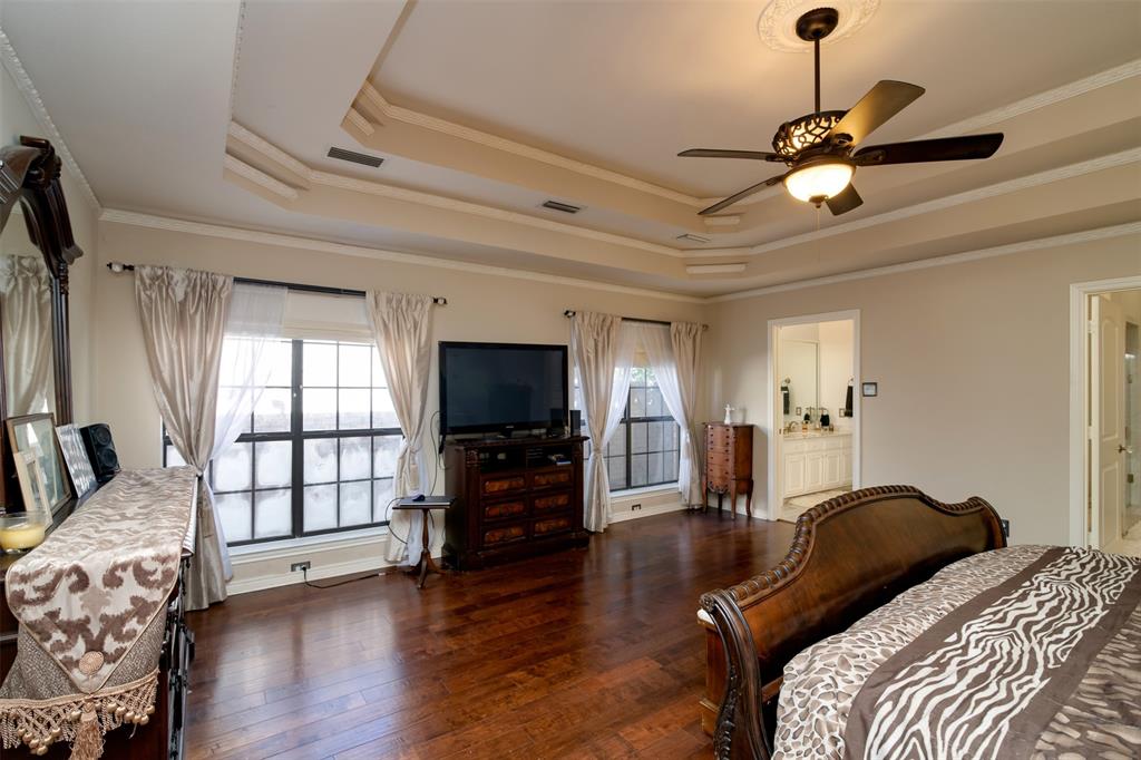 5920 Encore Drive Dallas, TX 75240 - Photo 16 of 34 Spacious interior room featuring wood-finish flooring, decorative tray ceiling, and an ornate ceiling fan