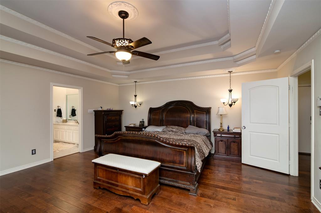 5920 Encore Drive Dallas, TX 75240 - Photo 17 of 34 Spacious room featuring wood-finish flooring, a coffered ceiling with crown molding, a decorative ceiling fan, and two wall sconces