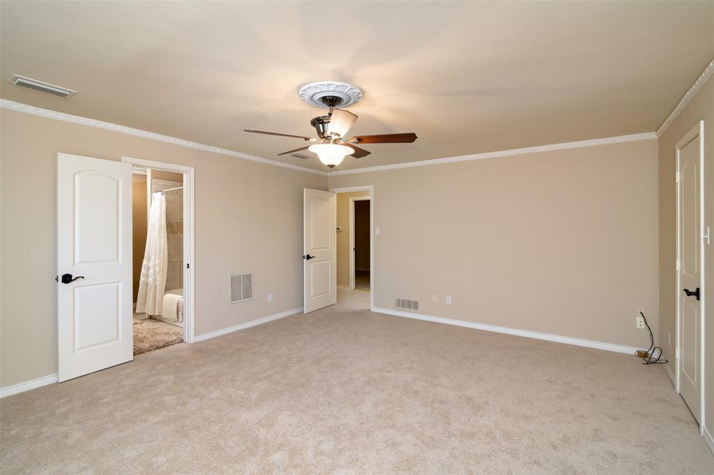5920 Encore Drive Dallas, TX 75240 - Photo 26 of 34 Spacious carpeted room featuring crown molding, a ceiling fan with light fixture, and two panel doors with black hardware