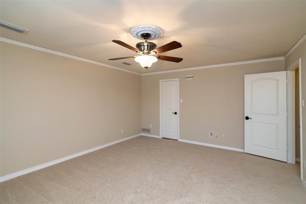 5920 Encore Drive Dallas, TX 75240 - Photo 28 of 34 Spacious room featuring neutral carpet flooring, light beige wall paint, white crown molding, and a decorative ceiling fan with a medallion