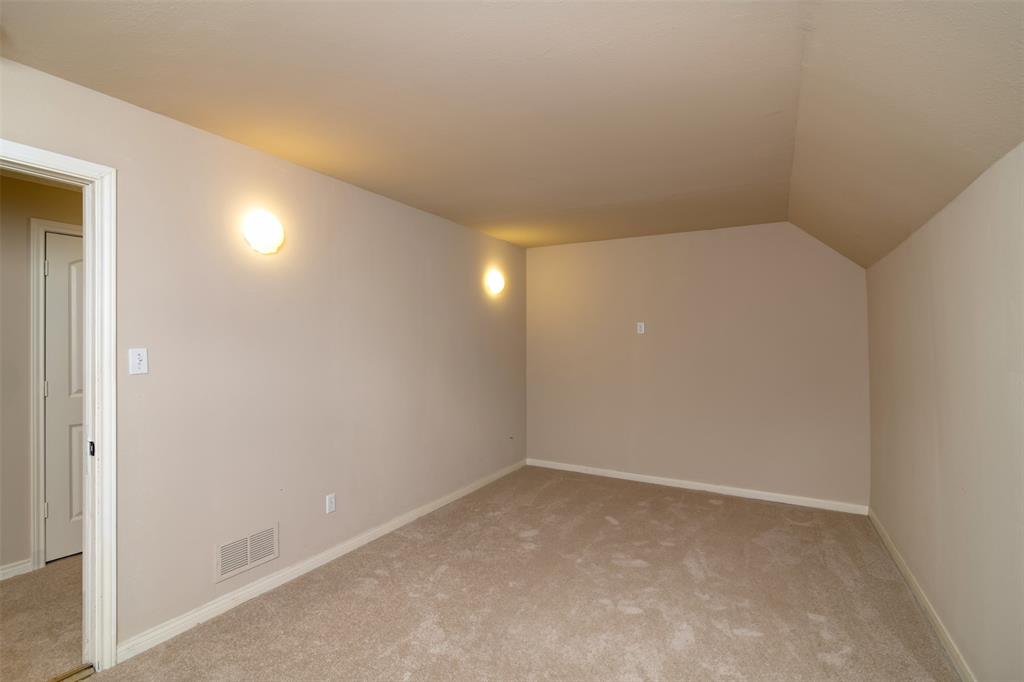 5920 Encore Drive Dallas, TX 75240 - Photo 30 of 34 Carpeted room with neutral wall tones and a vaulted ceiling feature