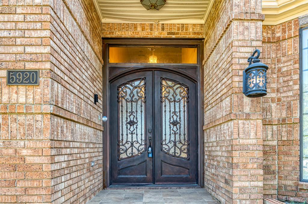 5920 Encore Drive Dallas, TX 75240 - Photo 3 of 34 Double entry doors with decorative ironwork and transom window