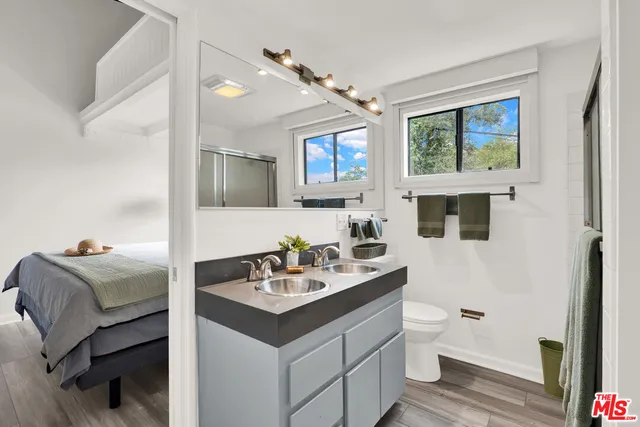 a en suite bathroom with a toilet sink and mirror