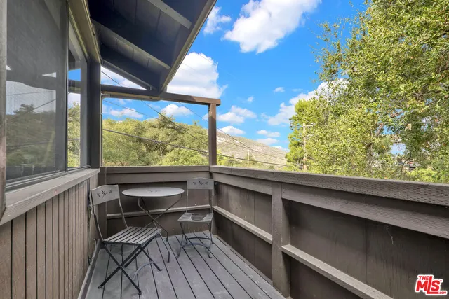 a view of a two chairs in the balcony