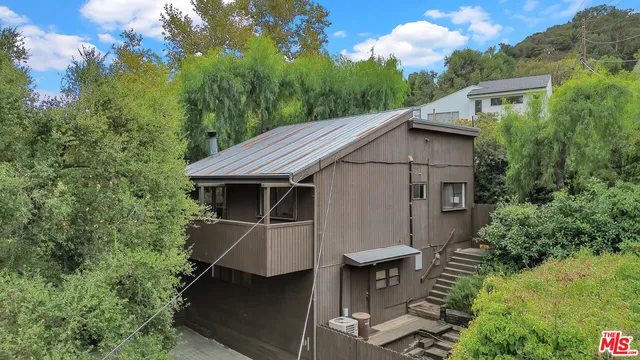 a aerial view of a house with yard and sitting area