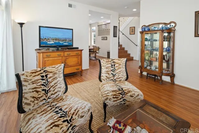 a bedroom with furniture and a flat screen tv