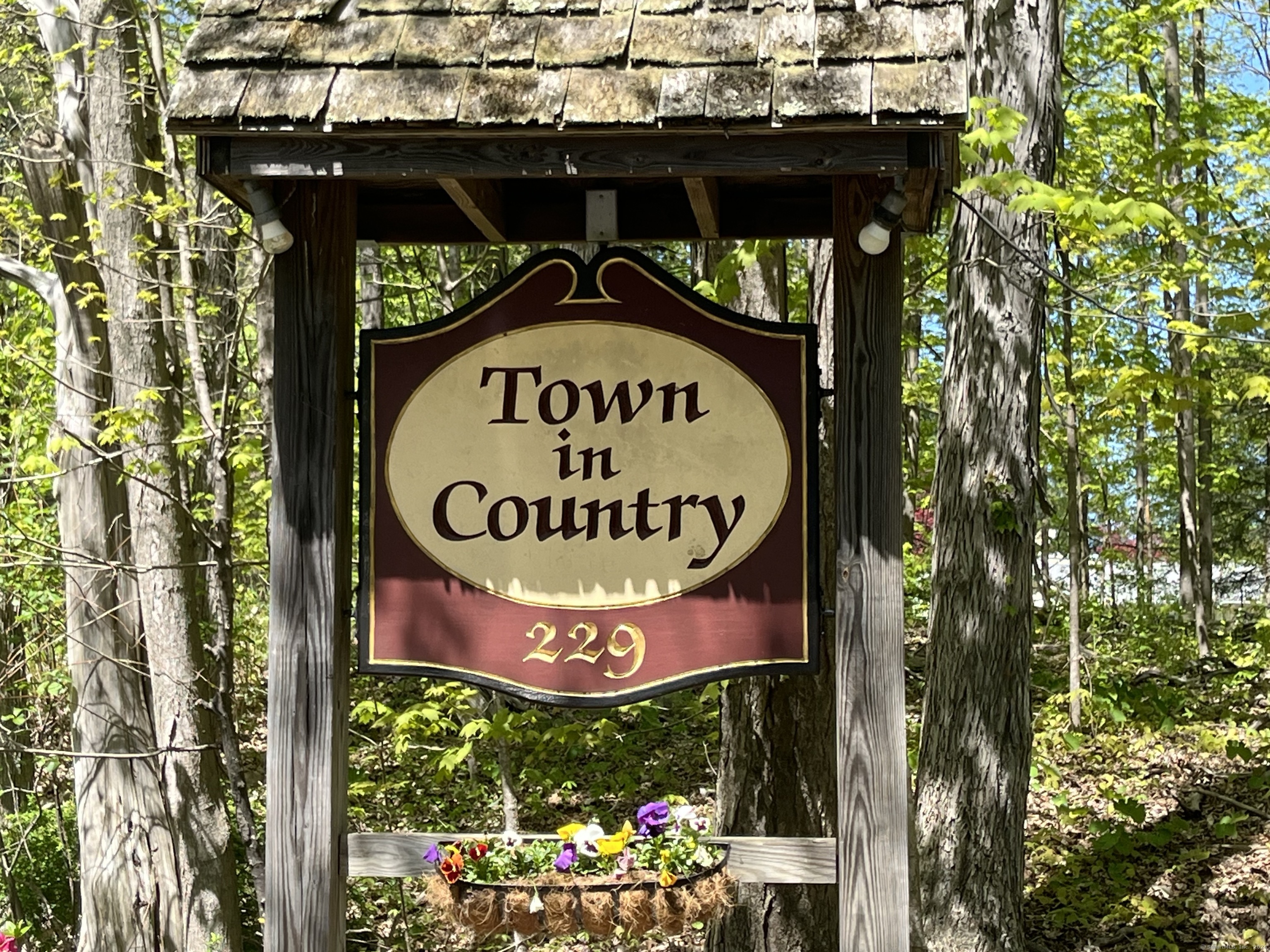 229 Bacon Pond Road, Unit 121 Woodbury, CT 06798 - Photo 1 of 1 a sign on a street sign