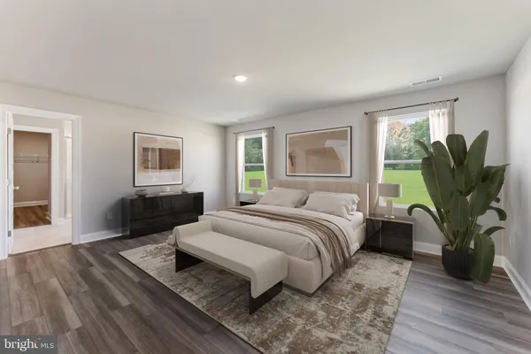 a living room with furniture and a view of kitchen