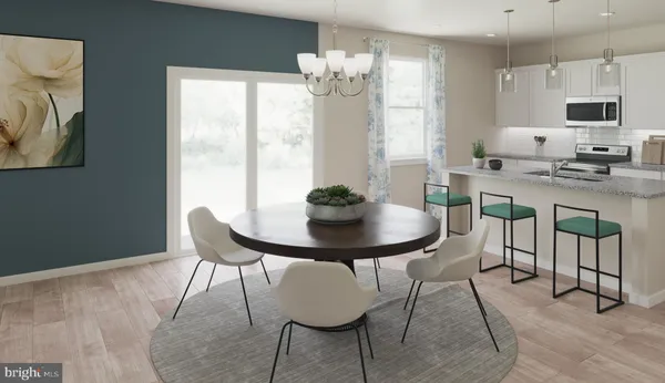 a view of a dining room with furniture and a large window