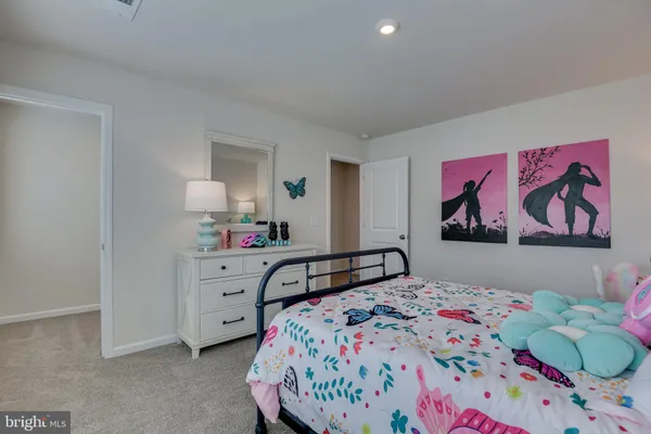 a living room with furniture kitchen view and a wooden floor