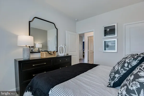 a bed sitting in a bedroom next to a window