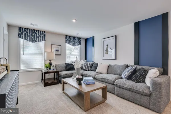 a bedroom with a bed chandelier and a window