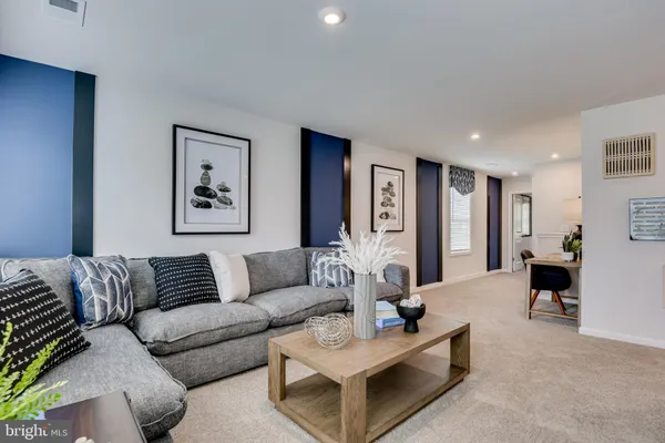 a bedroom with a white bed and ceiling fan