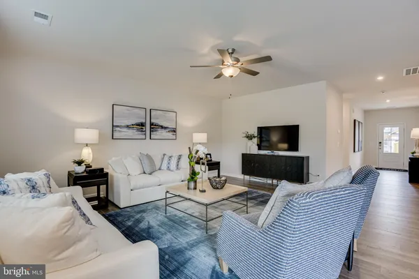a bathroom with a granite countertop sink mirror vanity and toilet