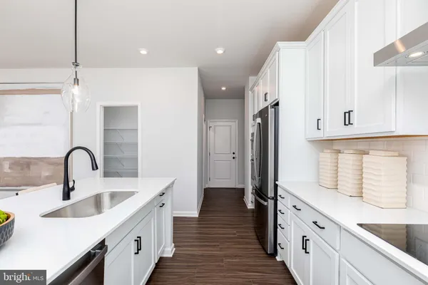 a spacious bathroom with a double vanity sink a mirror and a shower