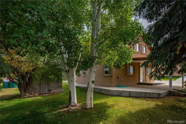 a view of a house with a backyard