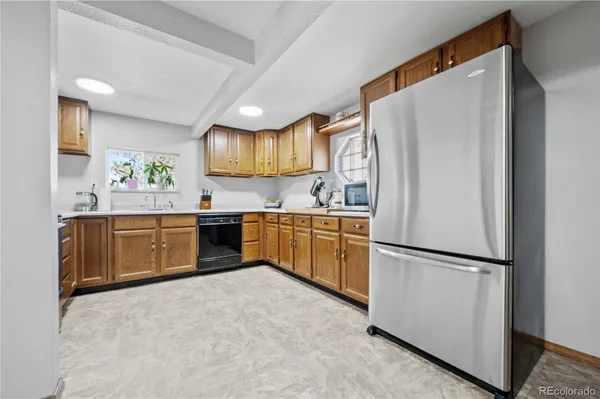 a kitchen with stainless steel appliances a refrigerator sink and cabinets