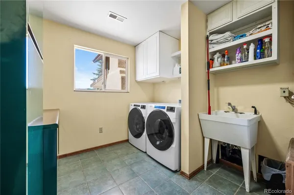 a utility room with cabinets dryer and washer