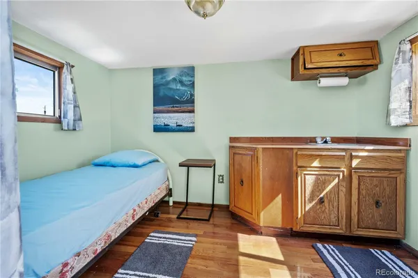 a bedroom with a bed and cabinets
