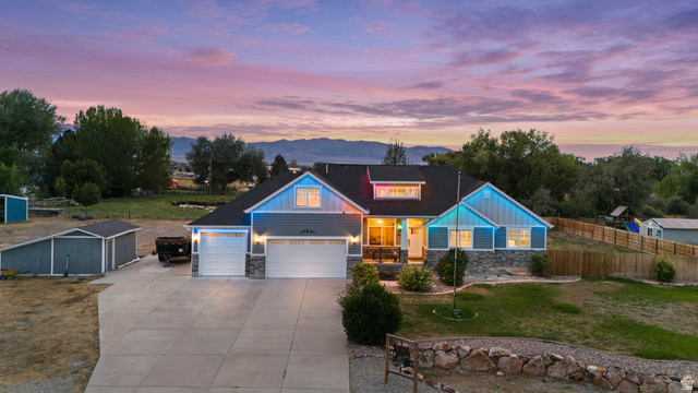 4557 North Ranch Road East Tooele, UT 84074 - Photo 41 of 43 Contemporary residence featuring a two-car garage, stone accents, and a paved driveway