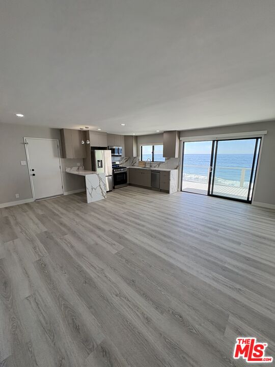 25216 1/2 Malibu Road Malibu, CA 90265 - Photo 4 of 6 a view of a livingroom with furniture and wooden floor