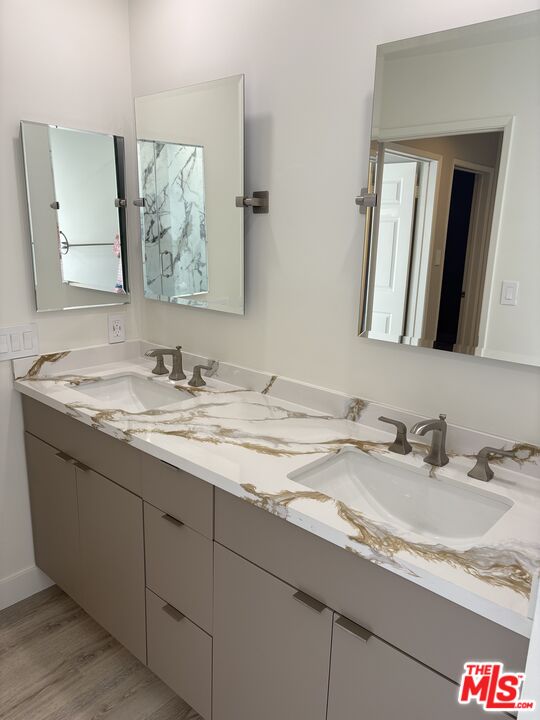 25216 1/2 Malibu Road Malibu, CA 90265 - Photo 5 of 6 a bathroom with a granite countertop sink and a mirror