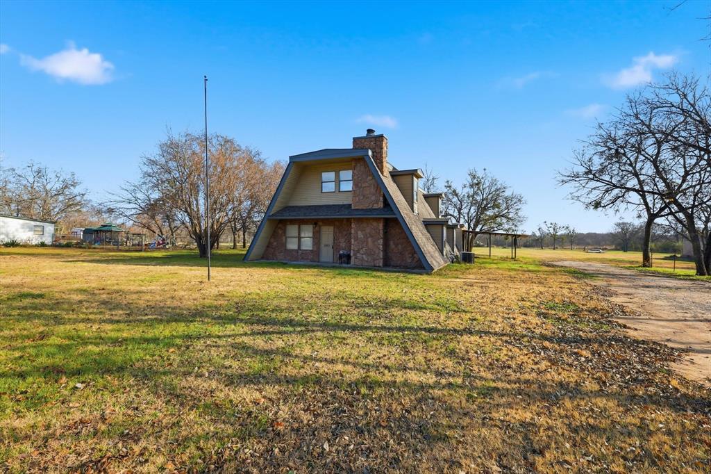 1401 South Walnut Street Cleburne, TX 76033 - Photo 21 of 23 a view of a house with a yard
