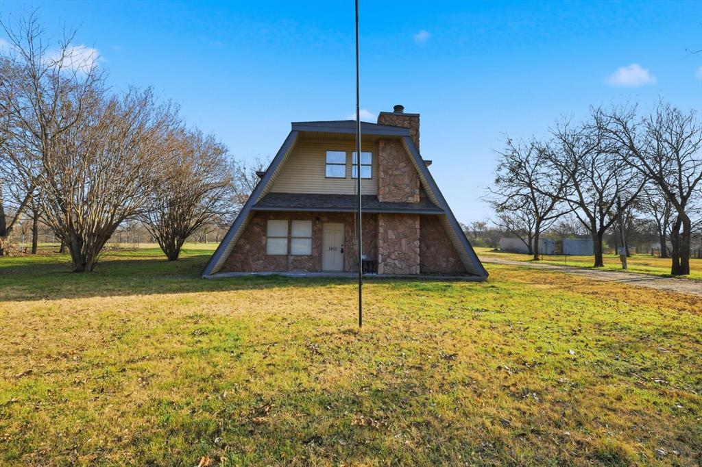 1401 South Walnut Street Cleburne, TX 76033 - Photo 22 of 23 a front view of a house with a yard