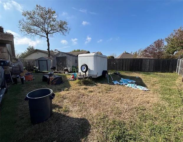 a view of a backyard with plants and trees