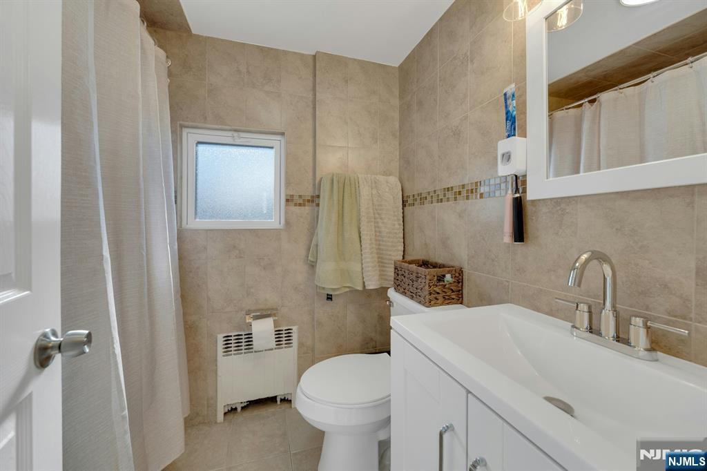 61 Christina Street, Unit 2 Little Ferry, NJ 07643 - Photo 17 of 18 a bathroom with a sink toilet and shower