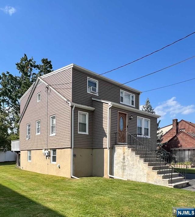 61 Christina Street, Unit 2 Little Ferry, NJ 07643 - Photo 2 of 18 a front view of a house with a yard
