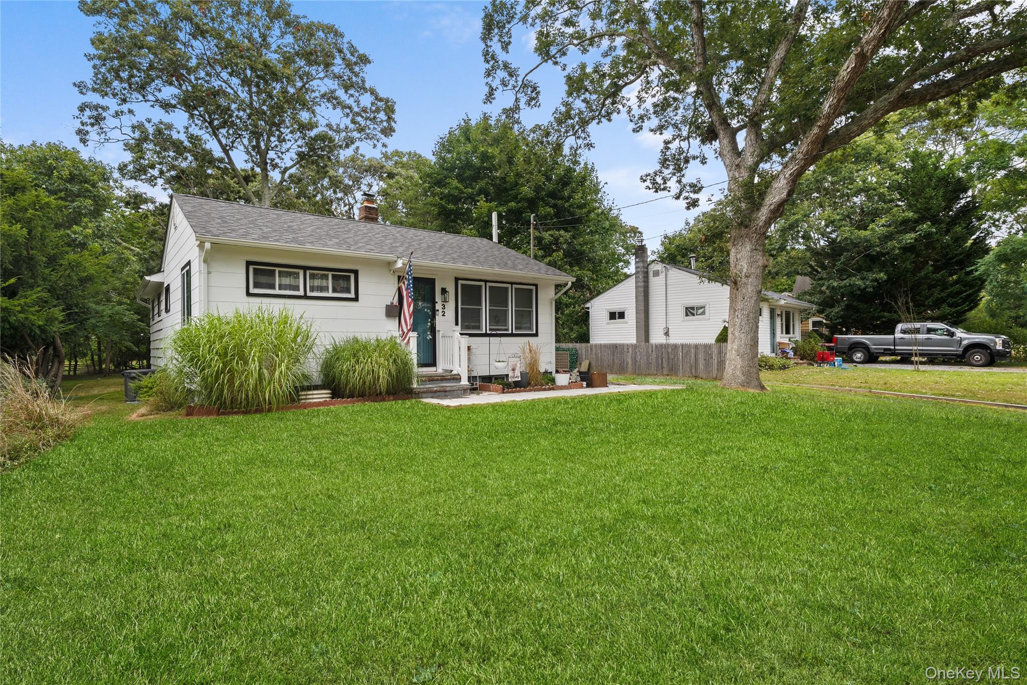 a front view of a house with a garden and yard
