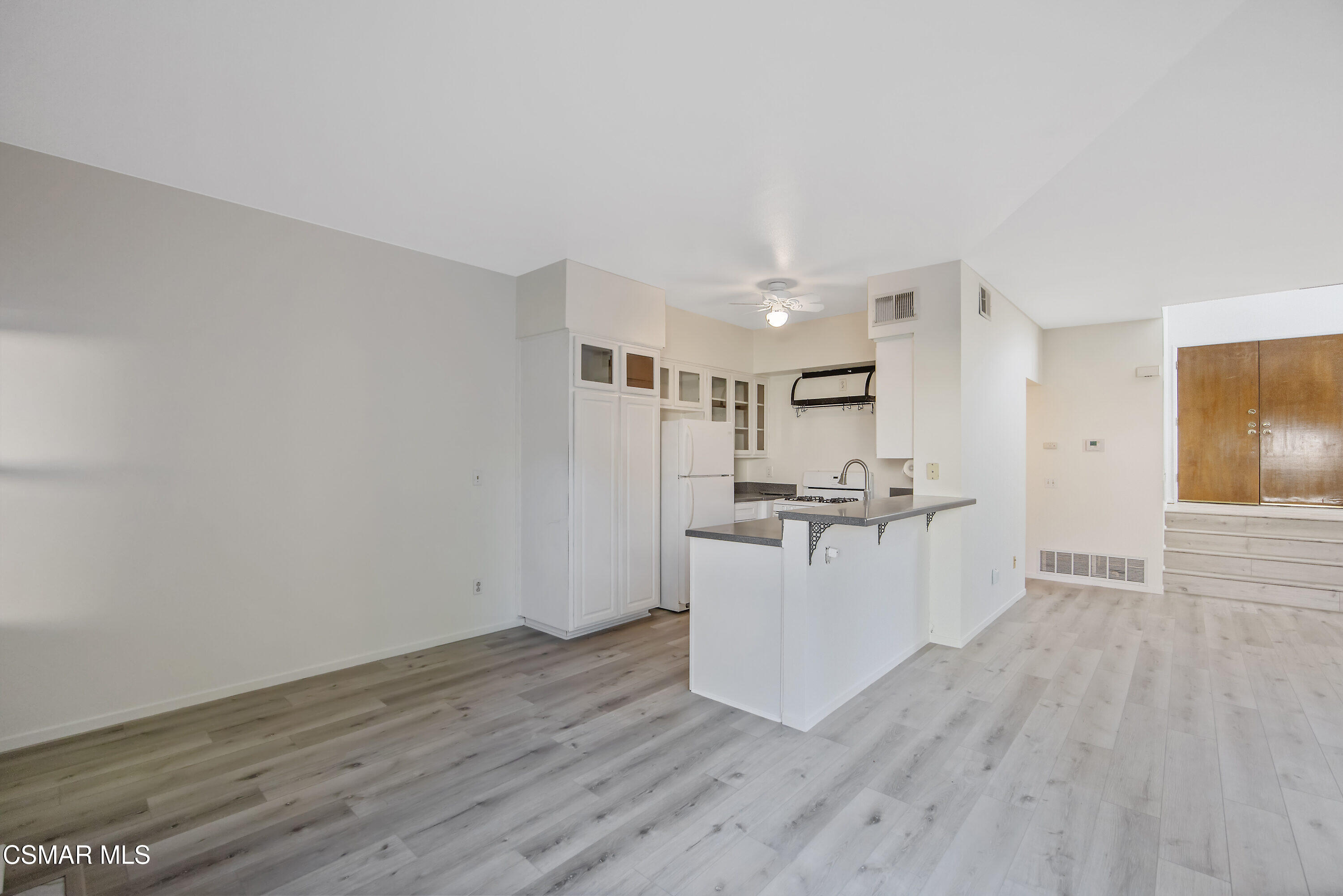11833 Nightingale Street Moorpark, CA 93021 - Photo 8 of 46 a view of a kitchen with wooden floor